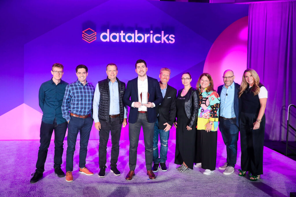 Hitachi team at the databricks event holding the award